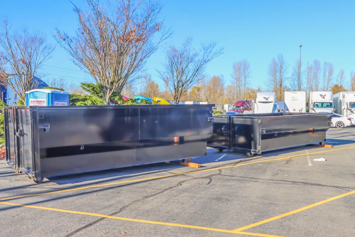 Professional dumpster rental service with roll-off container on residential driveway in Green Valley